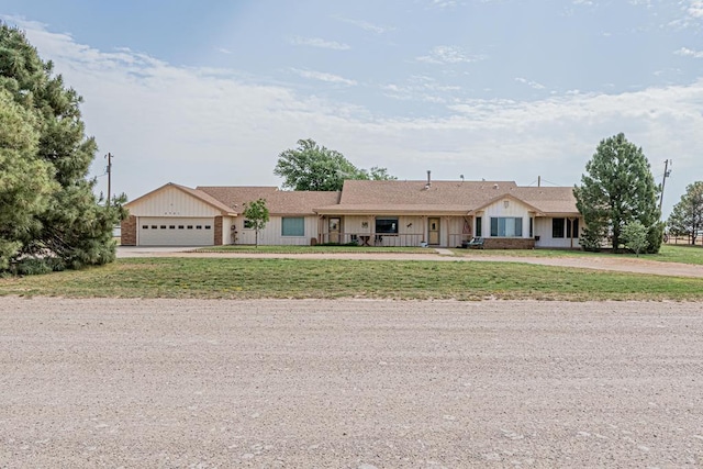 2701 S County Rd 1114, Midland, TX 79706 - single story home with curved driveway, an attached garage, and a front lawn