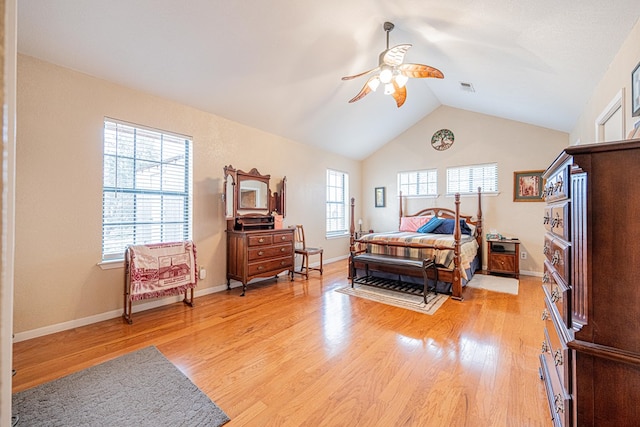 bedroom featuring light wood-style flooring, visible vents, a ceiling fan, vaulted ceiling, and baseboards