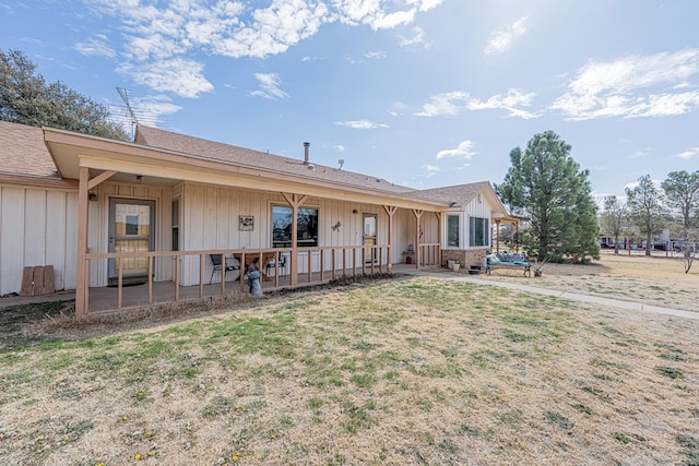 view of front of house with board and batten siding and a front yard