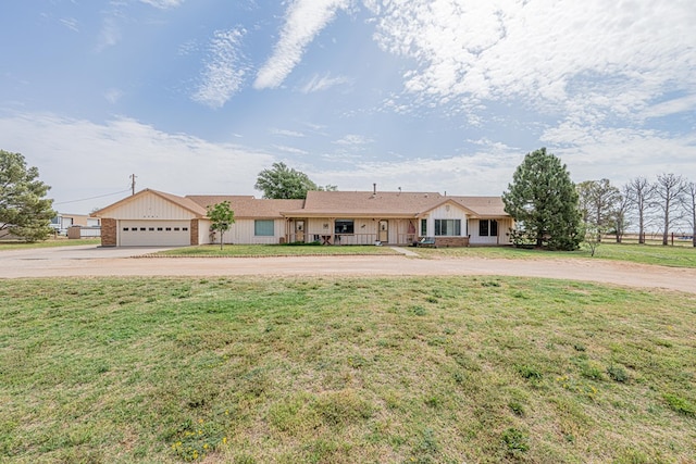2701 S County Rd 1114, Midland, TX 79706 - ranch-style house featuring a garage, curved driveway, board and batten siding, and a front yard