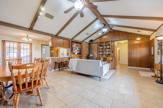 2701 S County Rd 1114, Midland, TX 79706 - living area featuring wooden walls, a textured ceiling, visible vents, and ceiling fan with notable chandelier