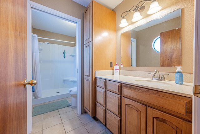 full bath featuring toilet, tile patterned flooring, a shower stall, and vanity