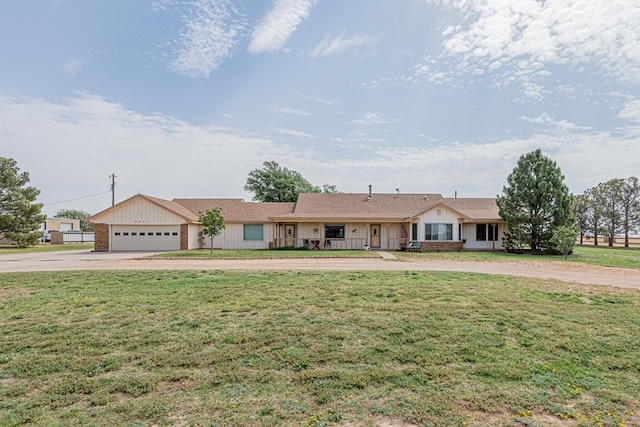 2701 S County Rd 1114, Midland, TX 79706 - ranch-style house featuring board and batten siding, an attached garage, curved driveway, and a front yard