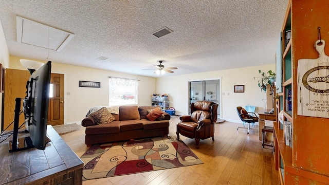 2701 S County Rd 1114, Midland, TX 79706 - living area featuring visible vents, attic access, a ceiling fan, and hardwood / wood-style flooring