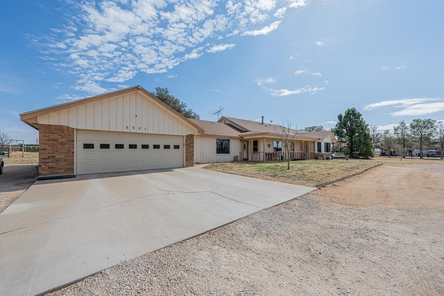 single story home featuring a garage, concrete driveway, and brick siding