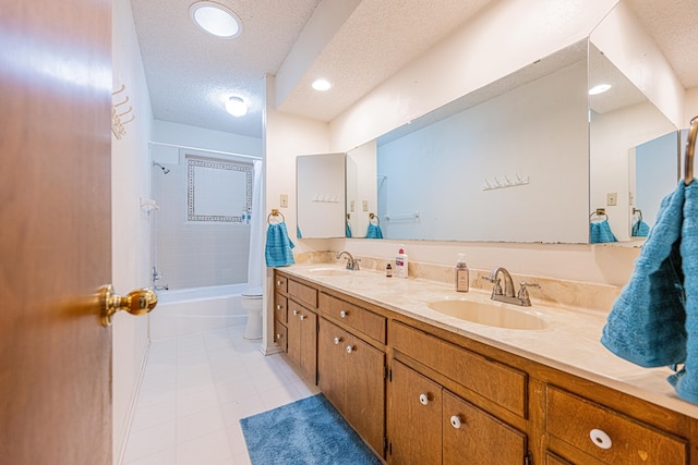 full bath featuring a textured ceiling, double vanity, bathtub / shower combination, and a sink