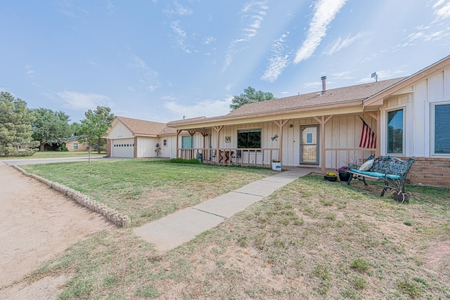 2701 S County Rd 1114, Midland, TX 79706 - view of front of home featuring a garage, board and batten siding, a front yard, concrete driveway, and covered porch