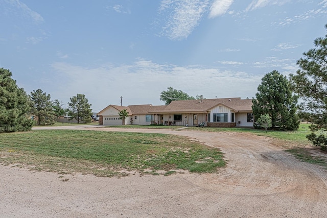 2701 S County Rd 1114, Midland, TX 79706 - single story home featuring curved driveway, an attached garage, a front lawn, and board and batten siding