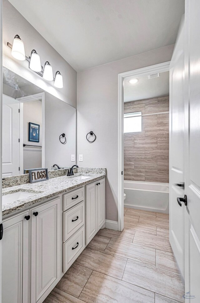 313 Peregrine Hill Cir, Midland, TX 79707 - bathroom featuring a sink, baseboards, double vanity, and shower / bath combination