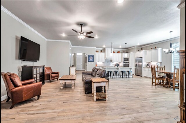 313 Peregrine Hill Cir, Midland, TX 79707 - living room with crown molding, recessed lighting, arched walkways, and ceiling fan with notable chandelier
