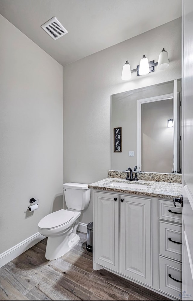 313 Peregrine Hill Cir, Midland, TX 79707 - bathroom with vanity, baseboards, toilet, visible vents, and wood finished floors