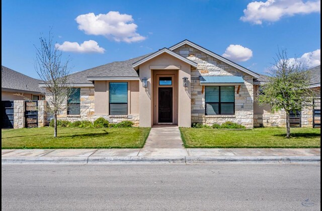 313 Peregrine Hill Cir, Midland, TX 79707 - view of front of house with roof with shingles, a front lawn, stone siding, and stucco siding