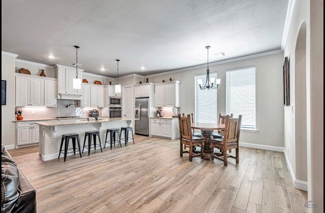 313 Peregrine Hill Cir, Midland, TX 79707 - dining room with baseboards, ornamental molding, a chandelier, recessed lighting, and light wood-style flooring