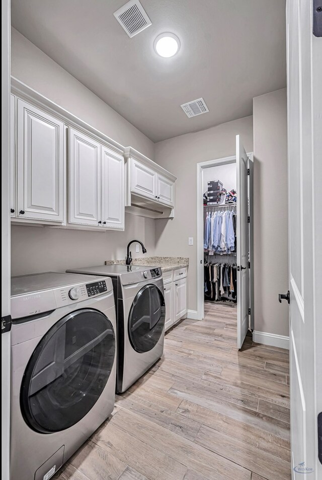 313 Peregrine Hill Cir, Midland, TX 79707 - clothes washing area with separate washer and dryer, baseboards, cabinet space, and visible vents