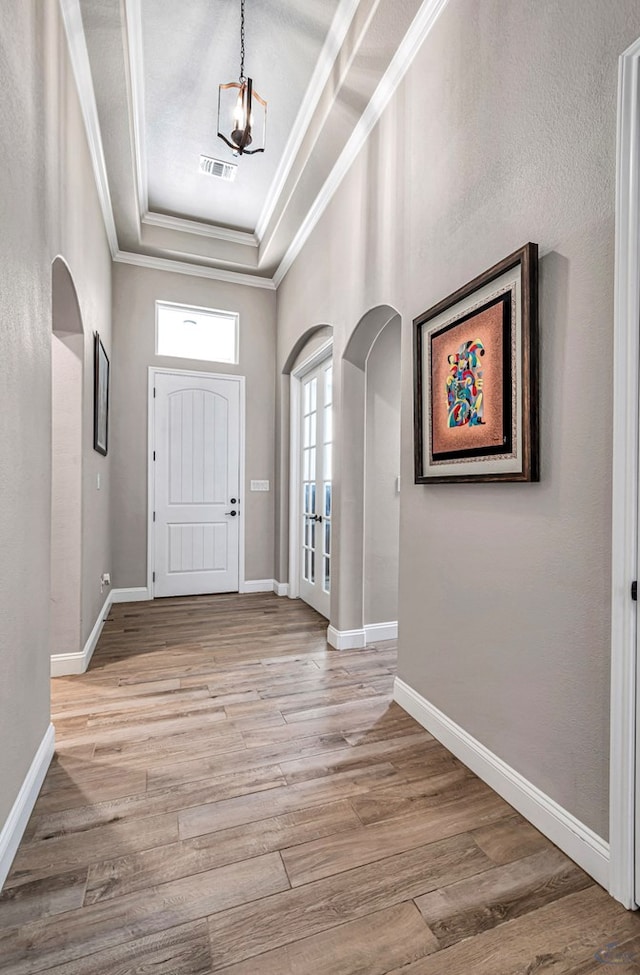313 Peregrine Hill Cir, Midland, TX 79707 - foyer entrance featuring arched walkways, light wood-style floors, visible vents, and crown molding