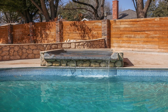 view of swimming pool featuring fence and a fenced in pool