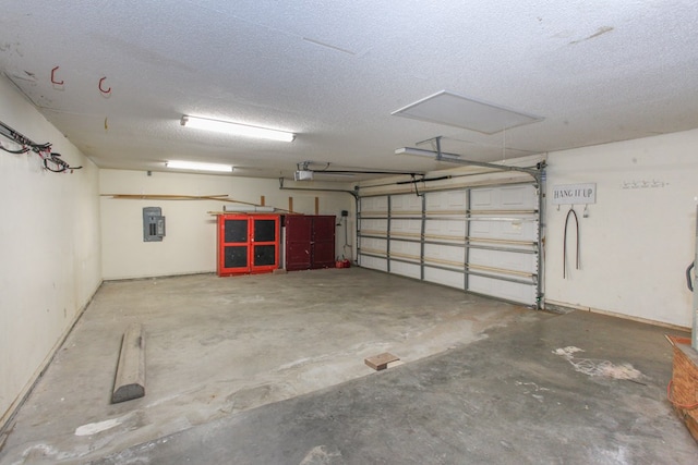 garage with electric panel and a garage door opener