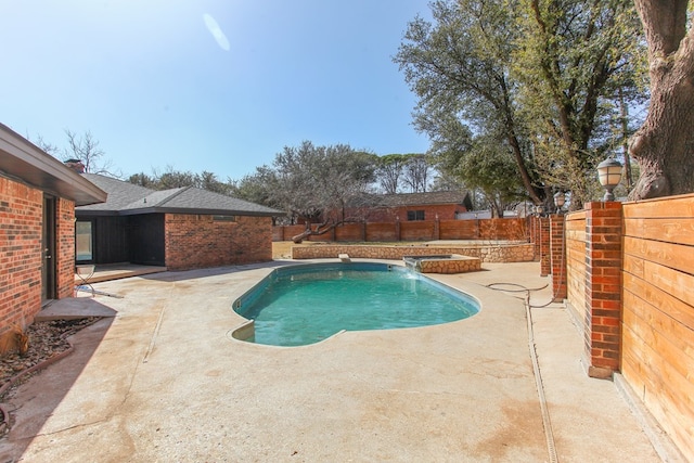 view of swimming pool with a fenced backyard, a fenced in pool, an in ground hot tub, and a patio