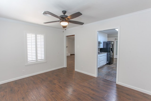 empty room featuring ceiling fan, baseboards, dark wood-style flooring, and crown molding