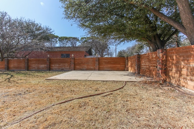 view of yard with a fenced backyard and a patio area