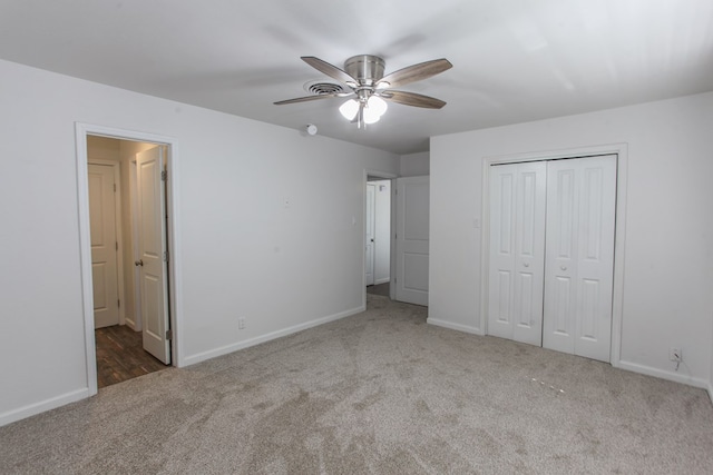 unfurnished bedroom featuring carpet, a closet, and baseboards