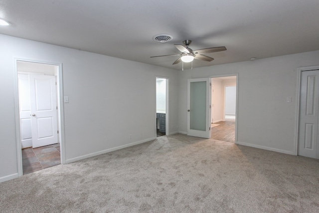 unfurnished bedroom with visible vents, carpet floors, baseboards, and ceiling fan