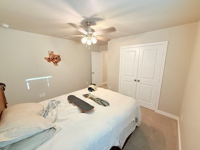 carpeted bedroom with a closet and ceiling fan