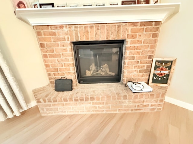 interior details featuring hardwood / wood-style flooring and a fireplace