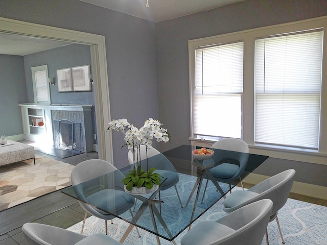 dining area with a fireplace and a wealth of natural light