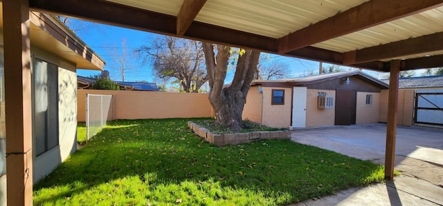 view of yard with a fenced backyard, an outdoor structure, and a patio