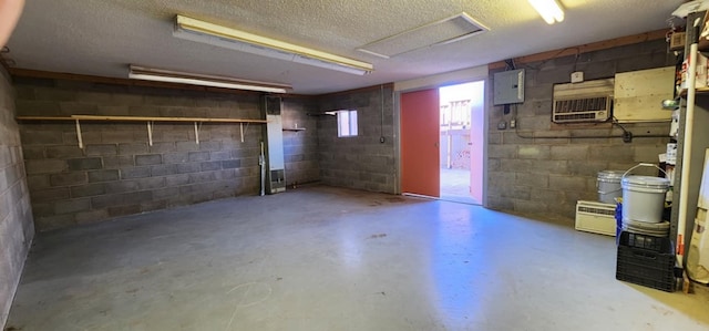 basement featuring concrete block wall, electric panel, and a textured ceiling