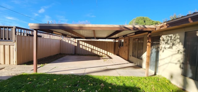 view of patio / terrace featuring a carport and fence