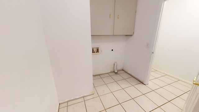 laundry room with hookup for a washing machine, cabinet space, light tile patterned floors, and hookup for an electric dryer