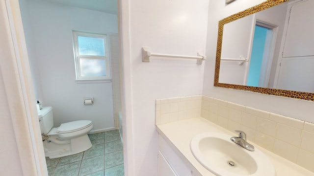 bathroom with toilet, tile patterned flooring, and vanity