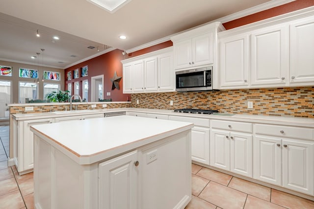 kitchen featuring a sink, a peninsula, light tile patterned flooring, and stainless steel appliances
