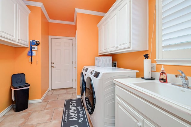 washroom with crown molding, washing machine and dryer, baseboards, cabinet space, and light tile patterned floors