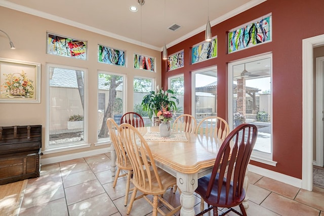 dining area featuring visible vents, baseboards, crown molding, and light tile patterned flooring