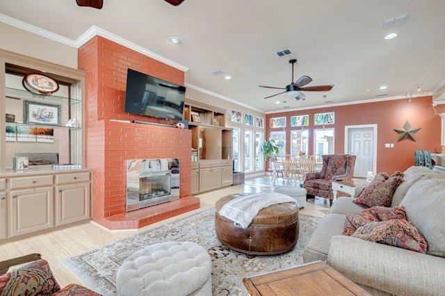 living room featuring visible vents, a ceiling fan, recessed lighting, and ornamental molding