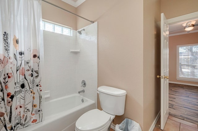 full bath featuring crown molding, shower / bathtub combination with curtain, a wealth of natural light, and toilet