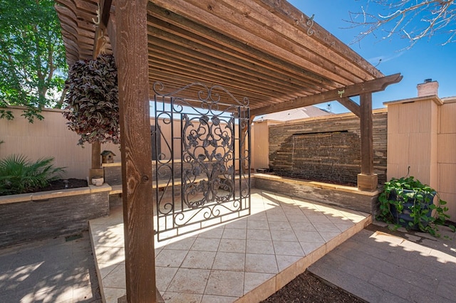 view of patio with a fenced backyard and a gate
