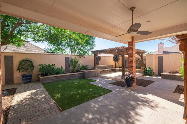 view of yard featuring an outbuilding, a fenced backyard, a shed, a patio, and a pergola