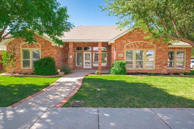 view of front of property featuring brick siding and a front lawn