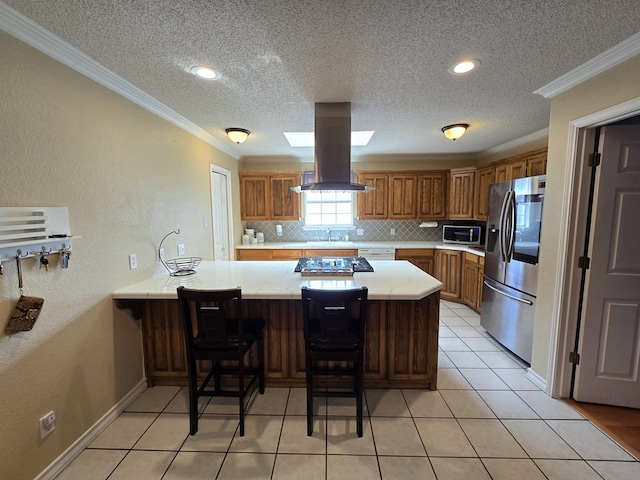 kitchen featuring a breakfast bar, kitchen peninsula, island exhaust hood, stainless steel appliances, and backsplash