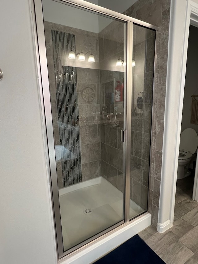 8409 E County Rd 113, Midland, TX 79706 - bathroom featuring a shower stall and toilet