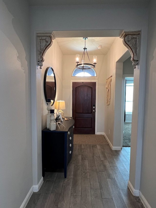 8409 E County Rd 113, Midland, TX 79706 - foyer with a chandelier, dark wood-style flooring, and baseboards
