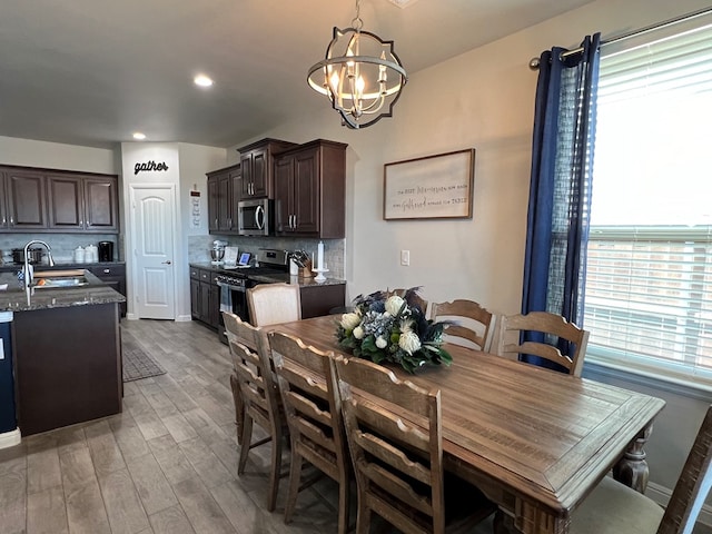 8409 E County Rd 113, Midland, TX 79706 - dining room featuring light wood-style flooring, a chandelier, and recessed lighting