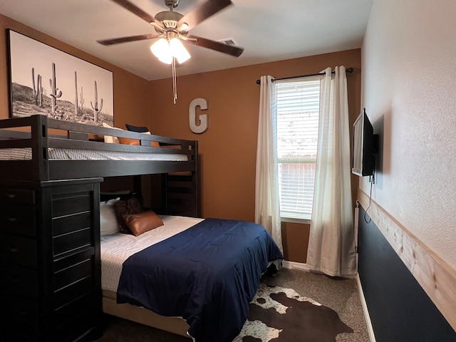 8409 E County Rd 113, Midland, TX 79706 - carpeted bedroom featuring baseboards, a ceiling fan, and a textured wall