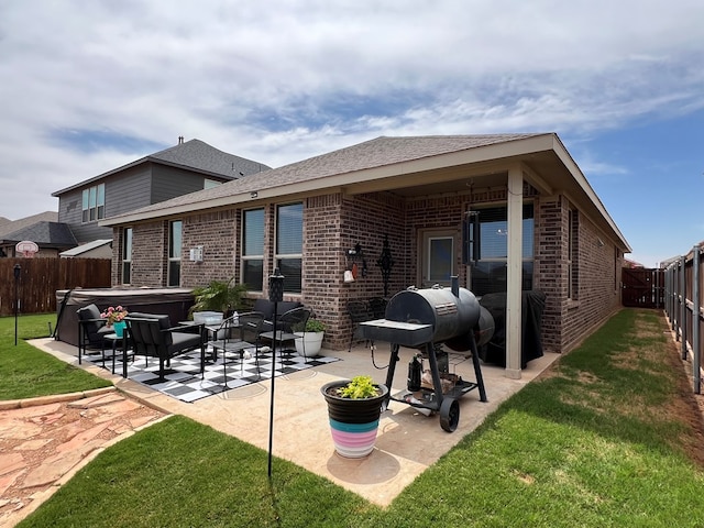 8409 E County Rd 113, Midland, TX 79706 - rear view of house featuring a hot tub, brick siding, a patio, and roof with shingles