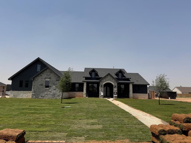 5605 E County Rd 94, Midland, TX 79706 - view of front of property with stone siding, a front lawn, and a shingled roof