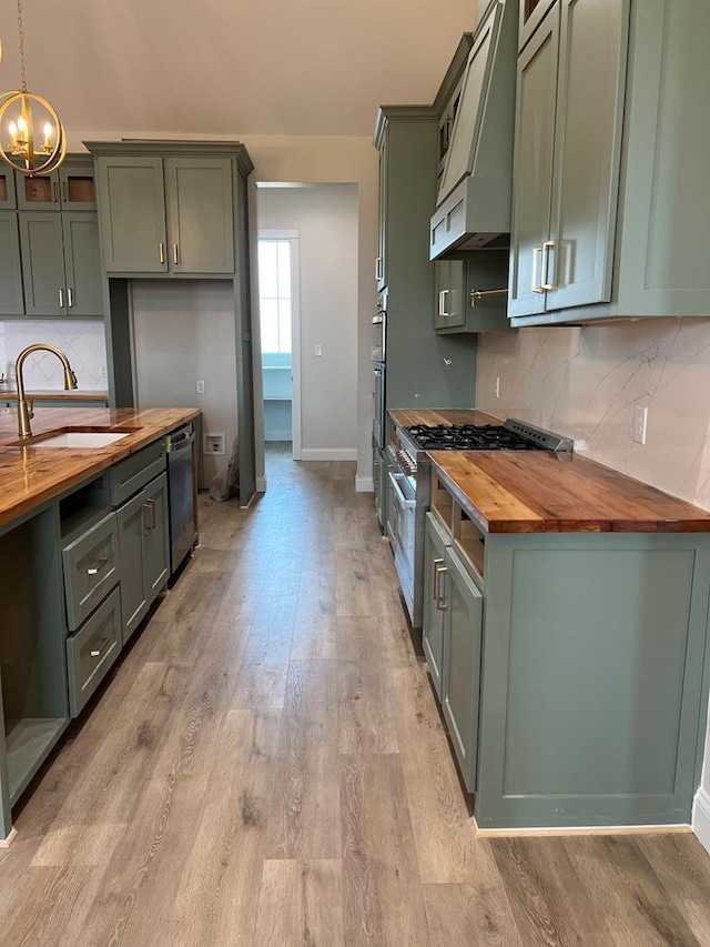 5605 E County Rd 94, Midland, TX 79706 - kitchen with wooden counters, custom exhaust hood, tasteful backsplash, and a chandelier